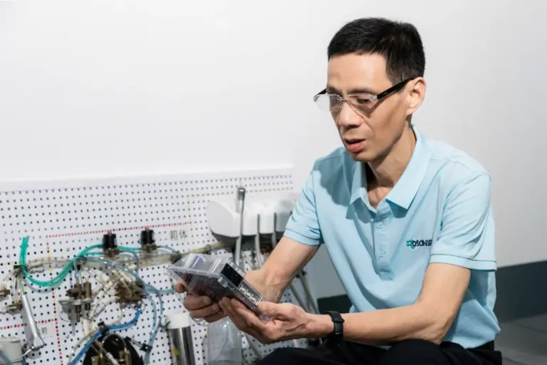 ROSON R&D team member inspecting dental product prototype for innovation and practice.