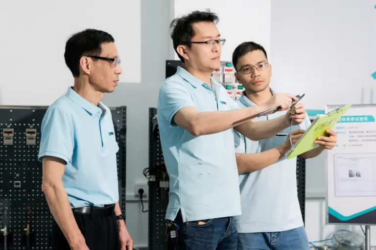ROSON R&D team members reviewing dental product design, innovation for practice, detailed technical drawings