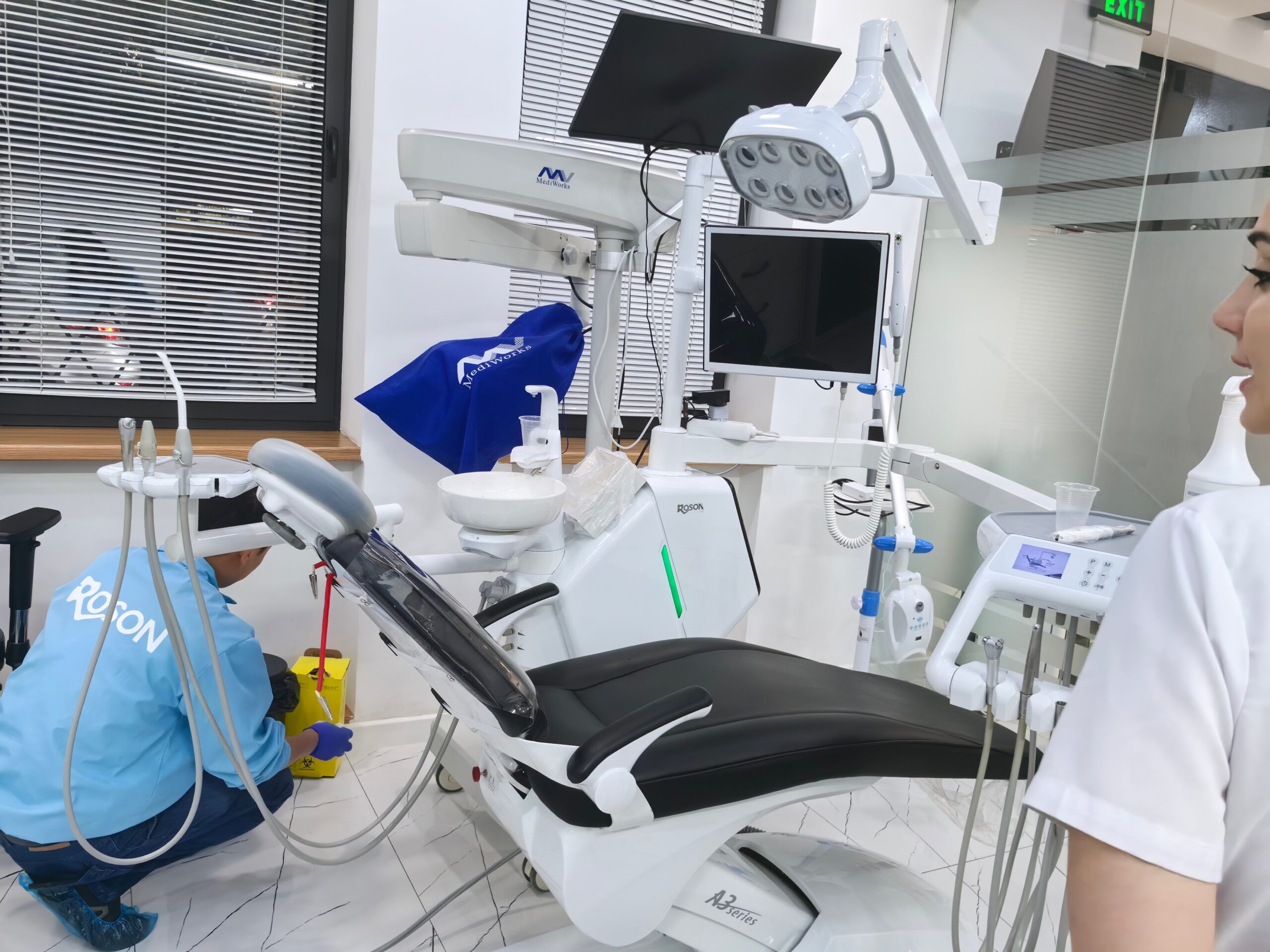 A clean and modern dental utility room showing a dental air compressor, dryer, and filtration system neatly installed.