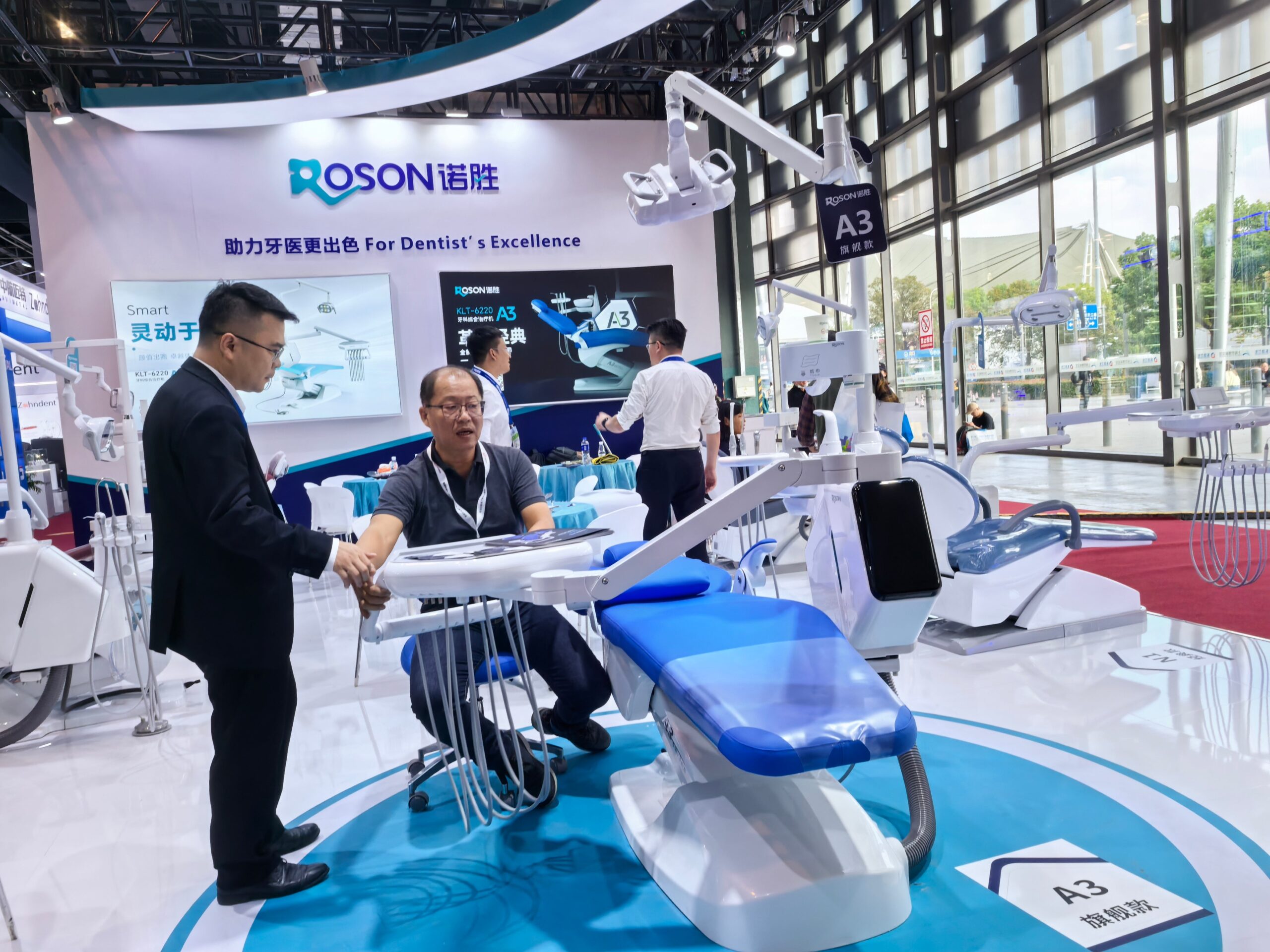 A modern Class B autoclave in a clean, professional dental clinic setting, with the door slightly ajar showing the internal chamber.